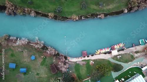 Aerial view flyover kibbutz Nir David, North of Israel. A view of farmland close to Beit shean valley with river channel dividing east and west side and Small Town With Red rooftops.