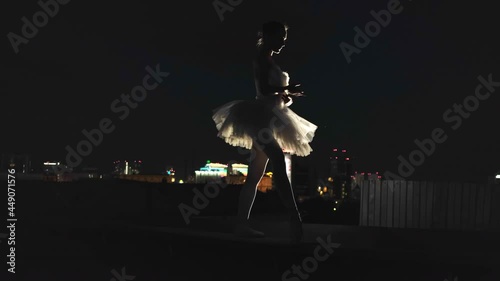 Silhouette ballerina repitition dance ballet in night city. Flexible girl dancer. Graceful performance dancing. Prepare dancers urban roof. Repitition silhouettes ballerinas. Woman preparing ballet. photo