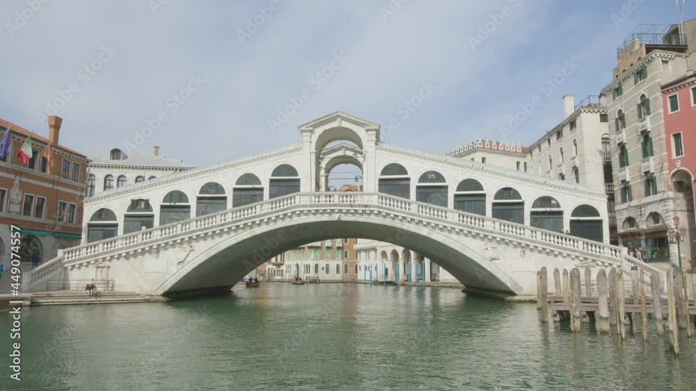 Tilt-up during the passage under the Rialto bridge with detail on the male head in keystone of the external central arch of the bridge Tilt-up during the passage under the Rialto bridge with detail on the male head in keystone of the external central arch of the bridge