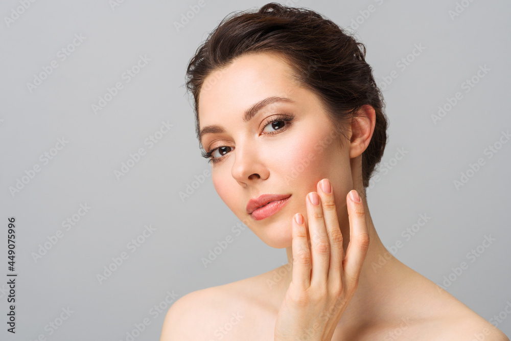 Young beautiful woman with perfect skin, touching her face. Cosmetology, beauty and spa concept. Young beautiful woman with perfect skin, touching her face. Cosmetology, beauty and spa concept.
