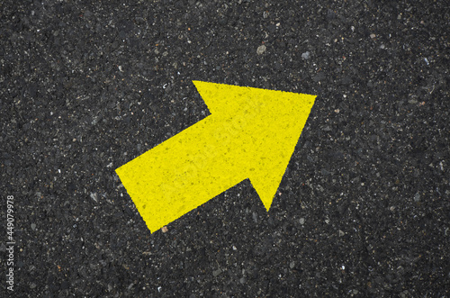 Asphalt with a yellow arrow sign pointing to the upper right. Tarmac road with an arrow pointing to the upper right  © sallies