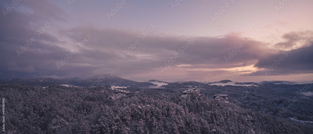 Majestic winter landscape during sunset in Bohemian Switzerland Dramatic wintry scene. Jetrichovice, Czech republic