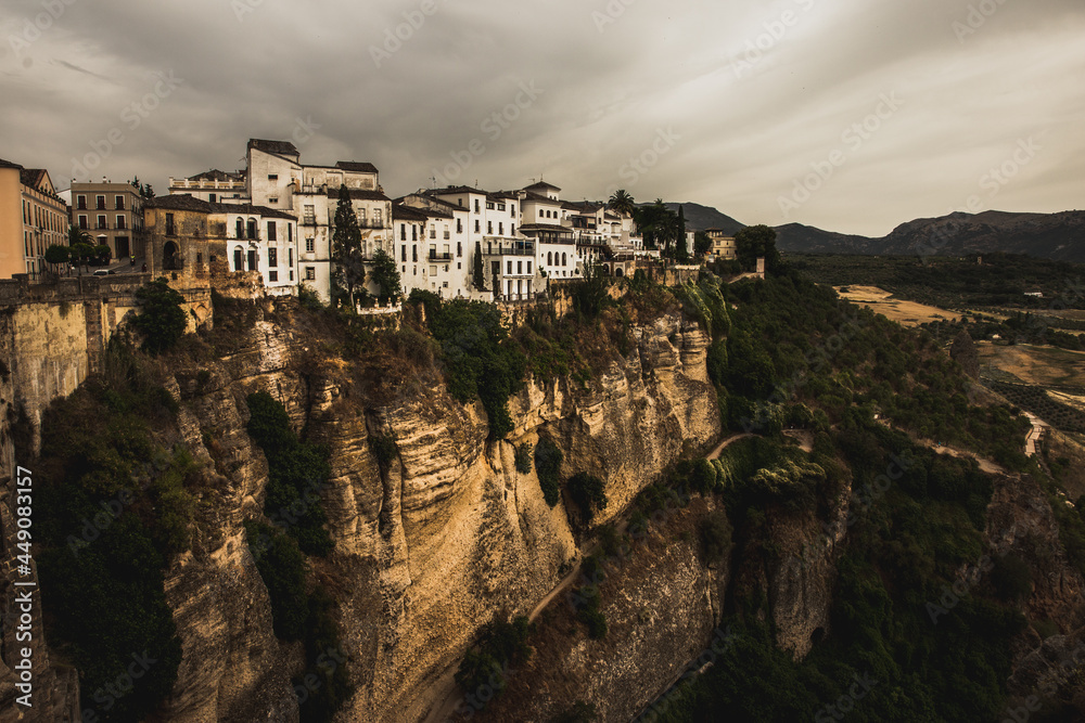 Ronda cliff and hanging houses with storm