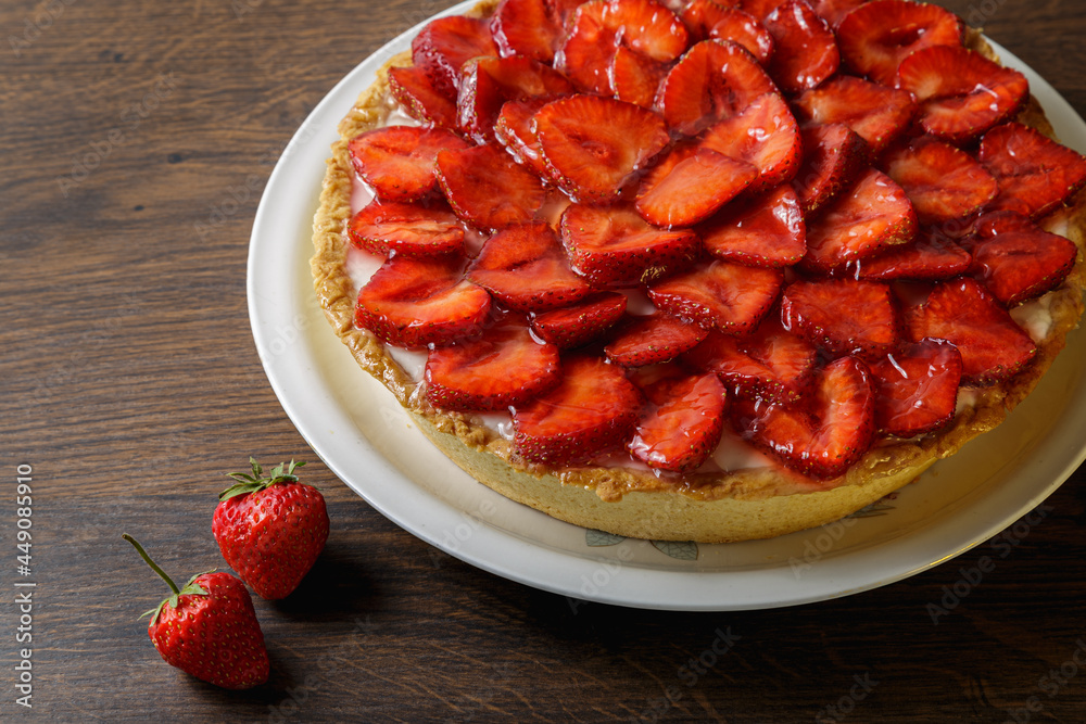 Homemade strawberry pie with syrup on a ceramic platter. Homemade strawberry pie with syrup on a ceramic platter.