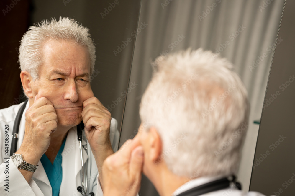 Doctor making funny faces in the mirror Doctor making funny faces in the mirror