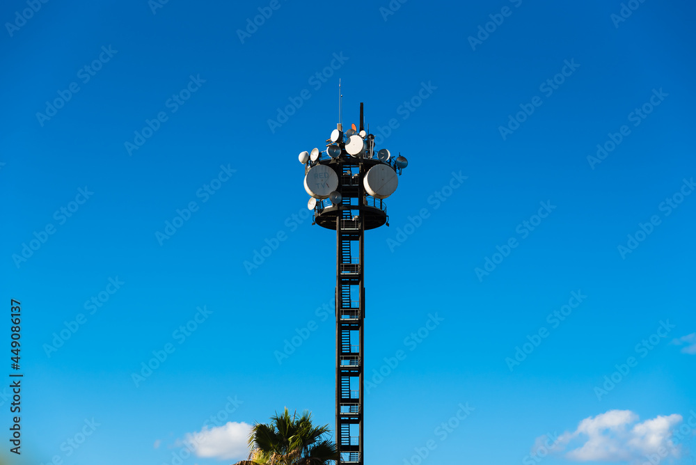 Large telecommunications tower full of radio and television broadcast antennas.