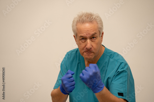 Photo of a angry doctor or nurse getting into a fight and making fists
