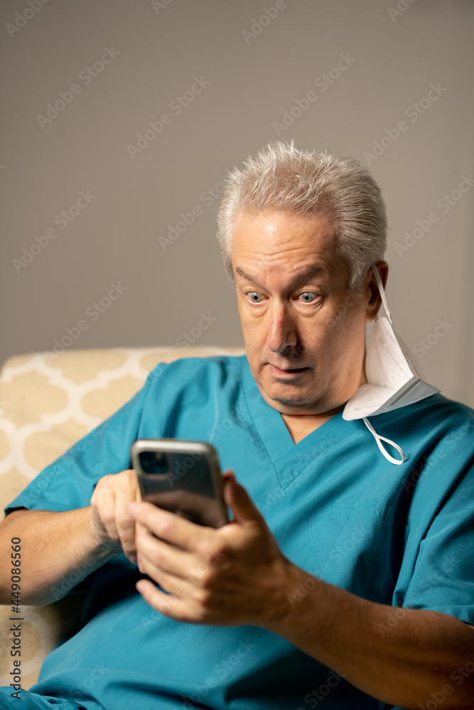 Fototapeta premium Photo of a doctor shocked while reading a phone text message
