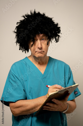 Male nurse with crazy hair taking notes on a note pad