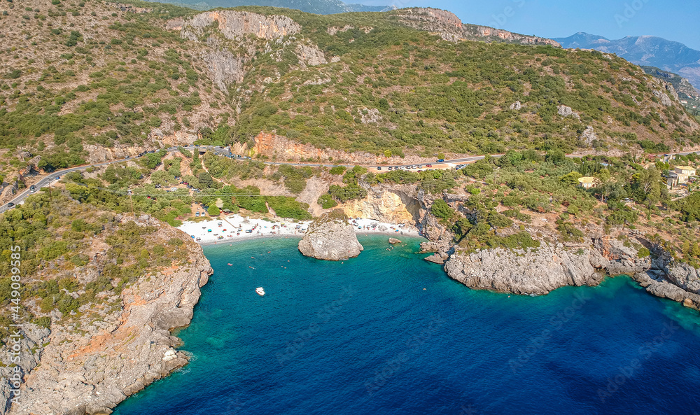 Obraz premium Aerial view of the famous rocky beach Foneas near Kardamyli village in the seaside Messenian Mani area during high tourist Summer period. Messenia, Peloponnese, Greece.