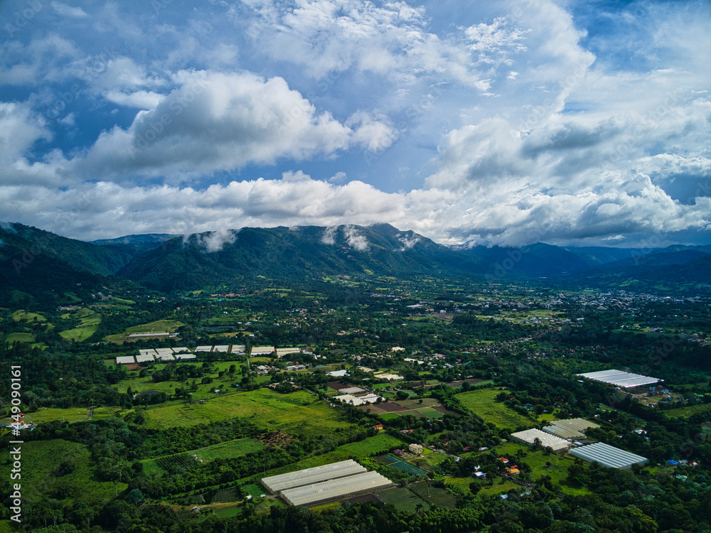 Jarabacoa aerial view in the afternoon with low clouds and mountains, caribbean weather