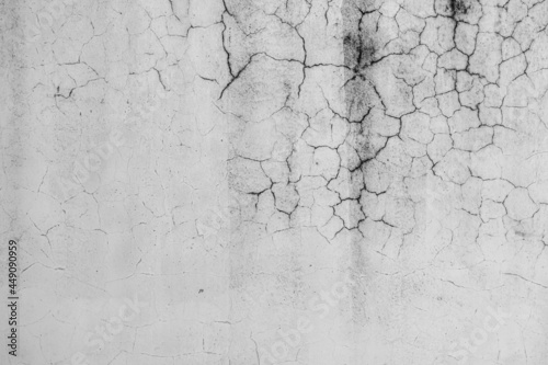 white grunge cement or concrete painted wall texture. White cement stone concrete plastered stucco wall painted. The cement crack wall background abstract gray concrete texture for interior design.