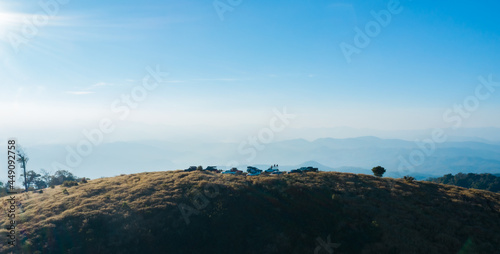 Aerial drone view of group of cars parking on the top of hill