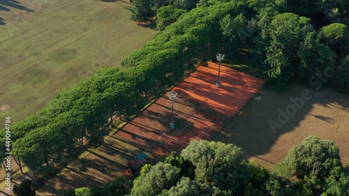 Tennis Court At The Surrounded With Lush Green Trees In Brijuni Islands, Croatia. aerial photo