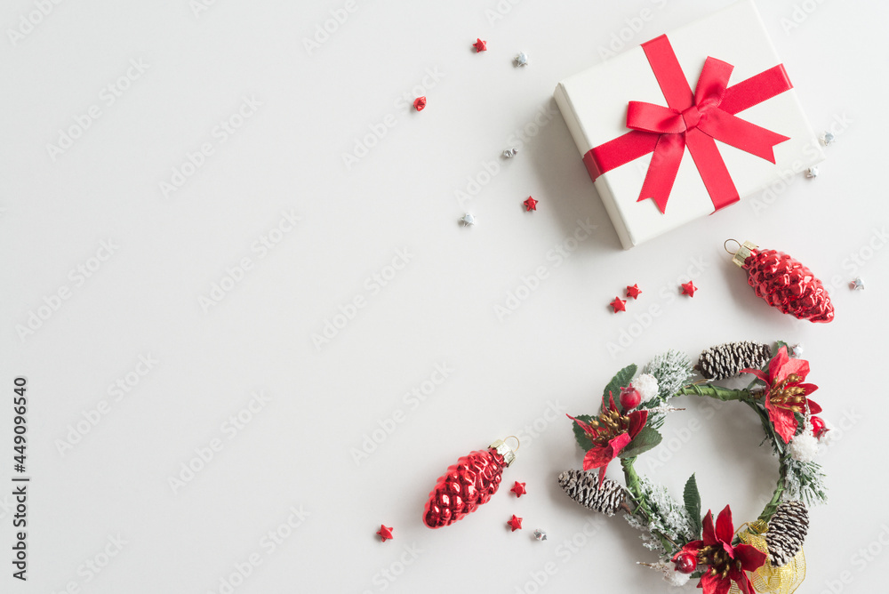 Flat lay of Christmas composition, gift box, wreath plant on white background copy space minimal style. Christmas ornament for decoration in xmas new year winter festival. Flat lay of Christmas composition, gift box, wreath plant on white background copy space minimal style. Christmas ornament for decoration in xmas new year winter festival.