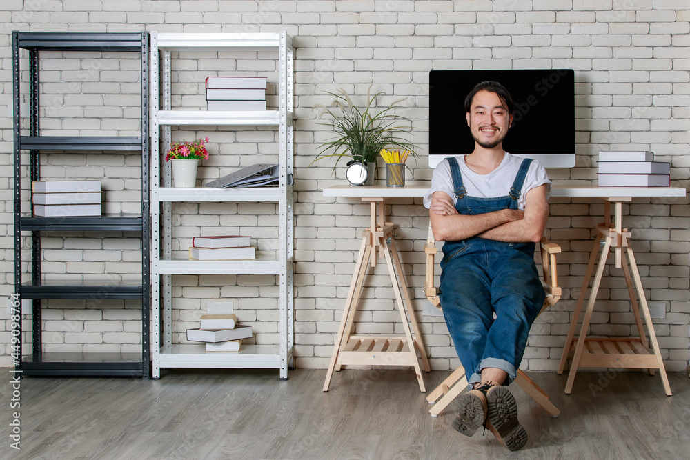 Young hipster beard Asian man happy in his new modern minimal startup office, concept for happy businessman at beginning