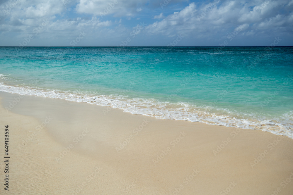 Soft foamy waves forming on a peaceful and relaxing sandy Beach in Grand Caymen.  