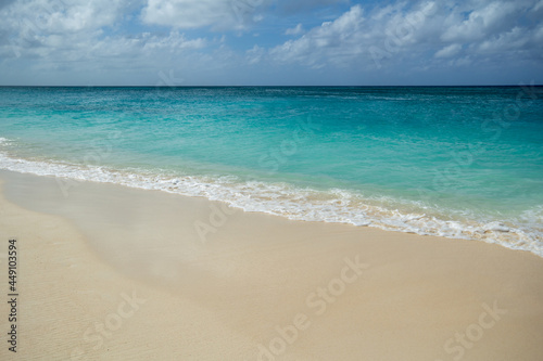 Soft foamy waves forming on a peaceful and relaxing sandy Beach in Grand Caymen.  