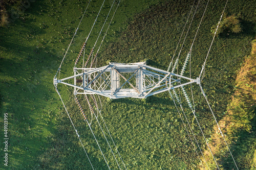 Transmission tower or pylon in top view. That substation, utility, infrastructure or steel structure for network of electrical grids system to carry high-voltage wire, cable or overhead power line.