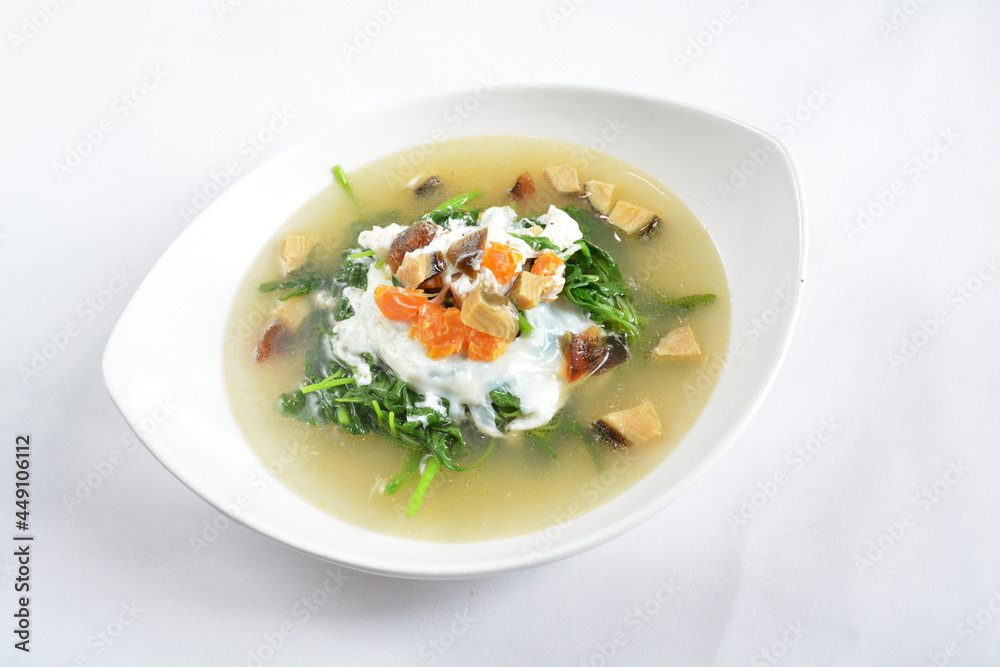 stir fried mixed vegetables spinach with 3 salted eggs in hot soup in white background asian halal menu stir fried mixed vegetables spinach with 3 salted eggs in hot soup in white background asian halal menu