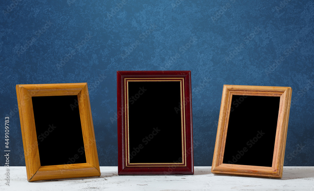 frames on table, blue wall frames on table, blue wall