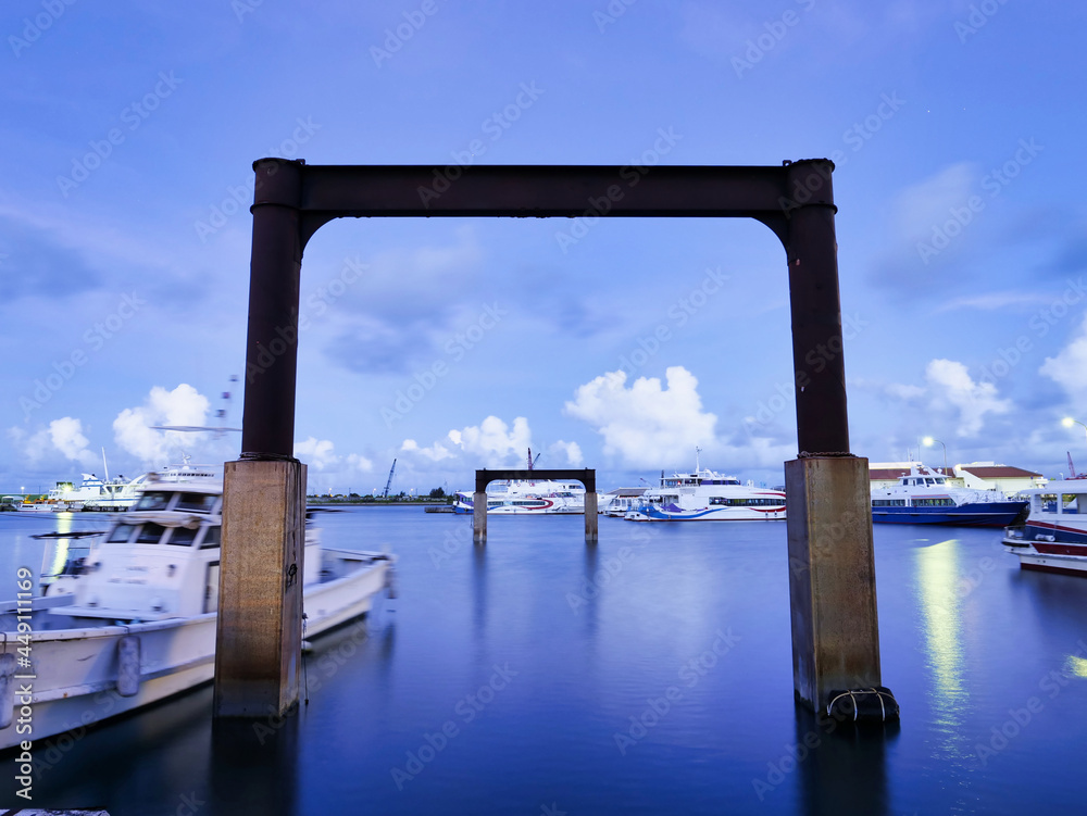 Okinawa,Japan - July 13, 2021: Disused Pillars of Floating pier at Ishigaki port in Ishigaki island, Okinawa, Japan, at dawn
