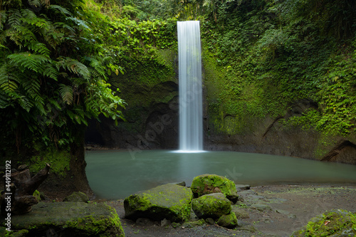 Waterfall landscape. Beautiful hidden waterfall in tropical rainforest. Nature background. Slow shutter speed, motion photography. Tibumana waterfall, Bali, Indonesia