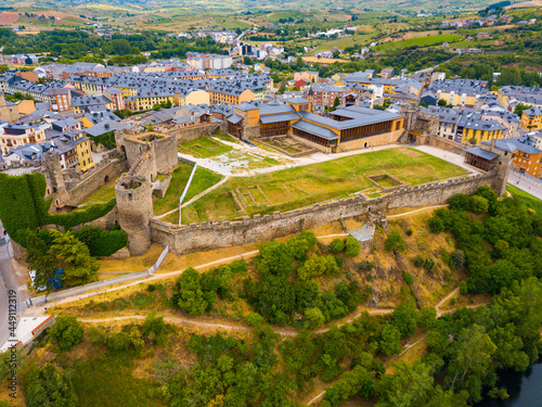 Aerial view of ancient Spanish Castillo de Ponferrada on background with cityscape in summer day