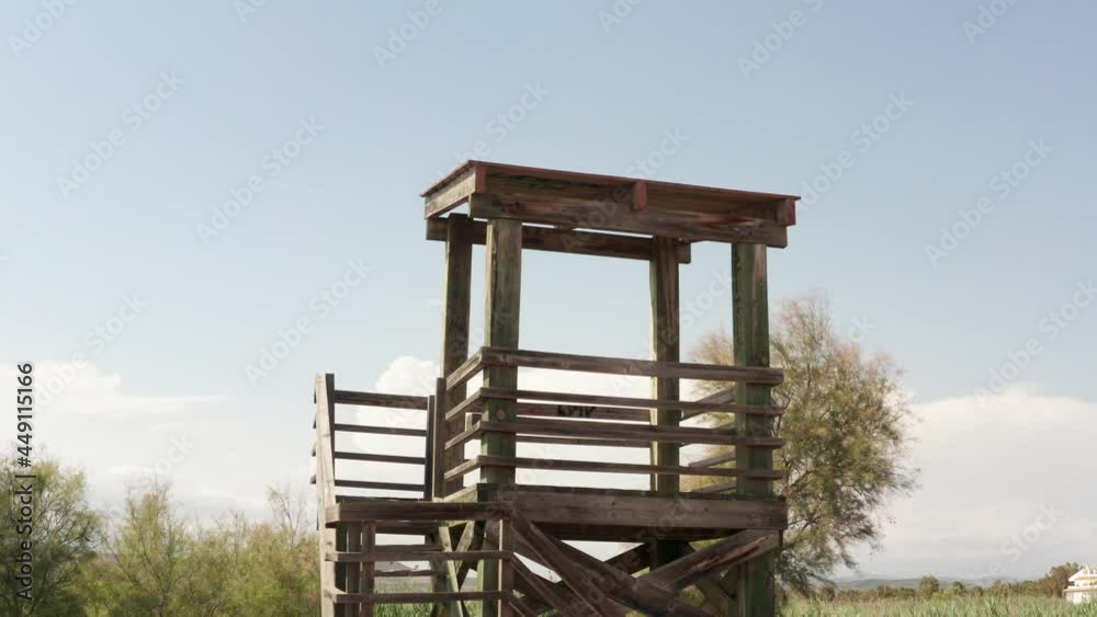 Wooden Tower With Clouds On Bright Sky In The Background. - wide shot