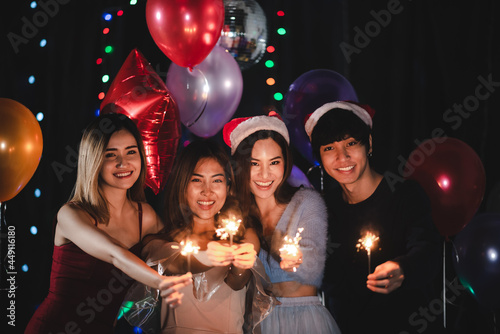 2021 to 2022 new year celebration party event with Asian young girl people who happy and fun together in a club, Asian women group in night light festival, lifestyle on stage show at nightclub