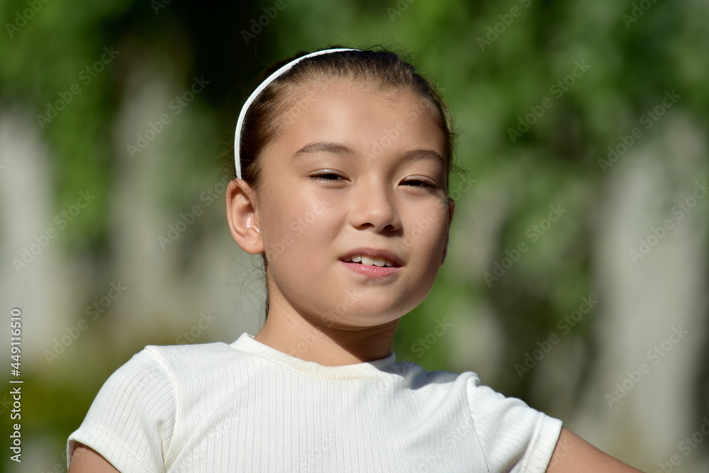 An Unemotional Asian Female Kid Outdoors An Unemotional Asian Female Kid Outdoors