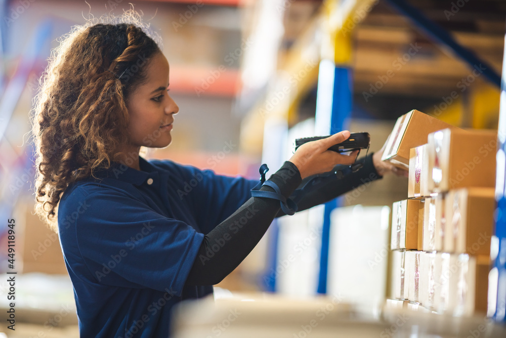 African American woman are work with business distribution inventory in warehouse factory, female people working in safety occupation job for shipping industry manufacturing - obrazy, fototapety, plakaty 