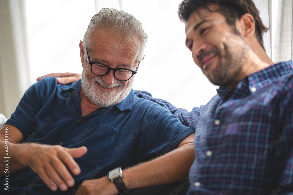 caucasian senior father and adult son are hugging together at home, generation family are happy with people love, male mature, old person man, elderly grandfather smiling living at the house