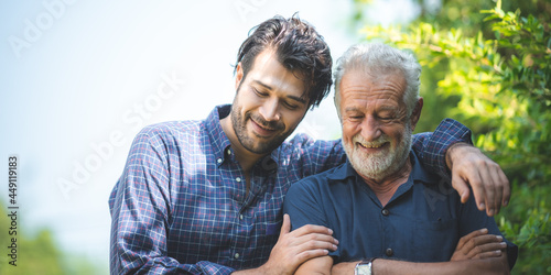 caucasian senior father and adult son are hugging together at home, generation family are happy with people love, male mature, old person man, elderly grandfather smiling living at the house