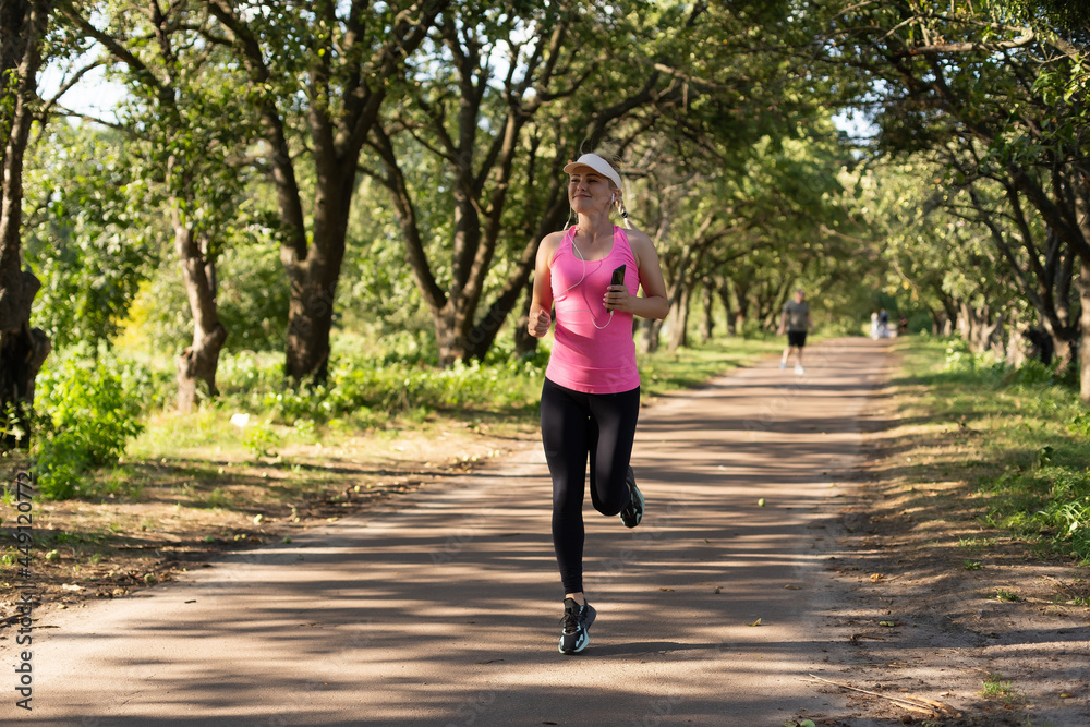 Running woman. Female Runner Jogging during Outdoor Workout in a Park. Running woman. Female Runner Jogging during Outdoor Workout in a Park.