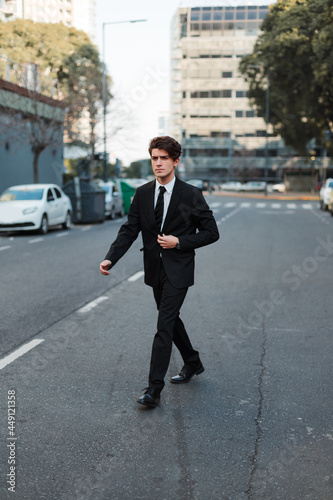 young man in casual suit walking down the street