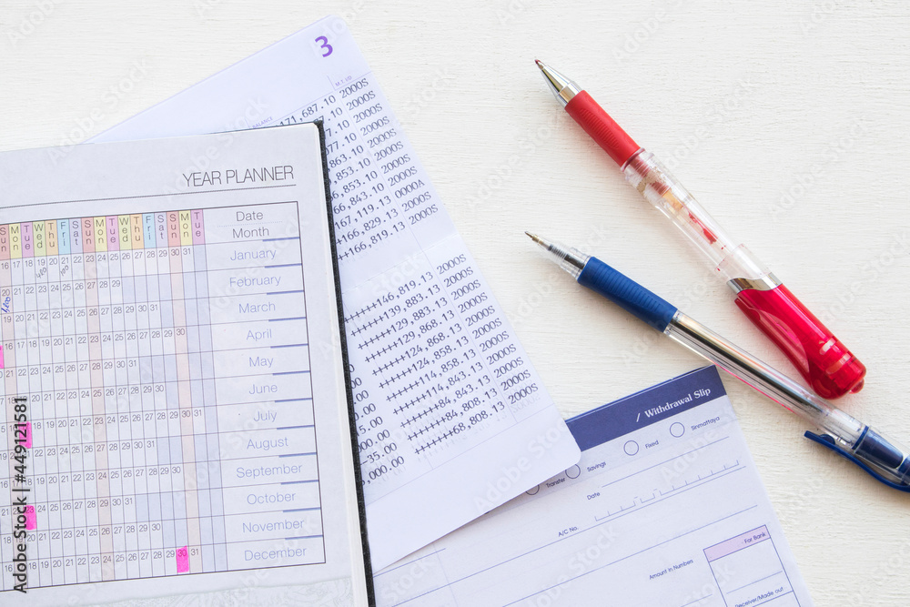 saving account pass book bank and withdrawal slip of bank with notebook planner arrangement flat lay style on background white saving account pass book bank and withdrawal slip of bank with notebook planner arrangement flat lay style on background white