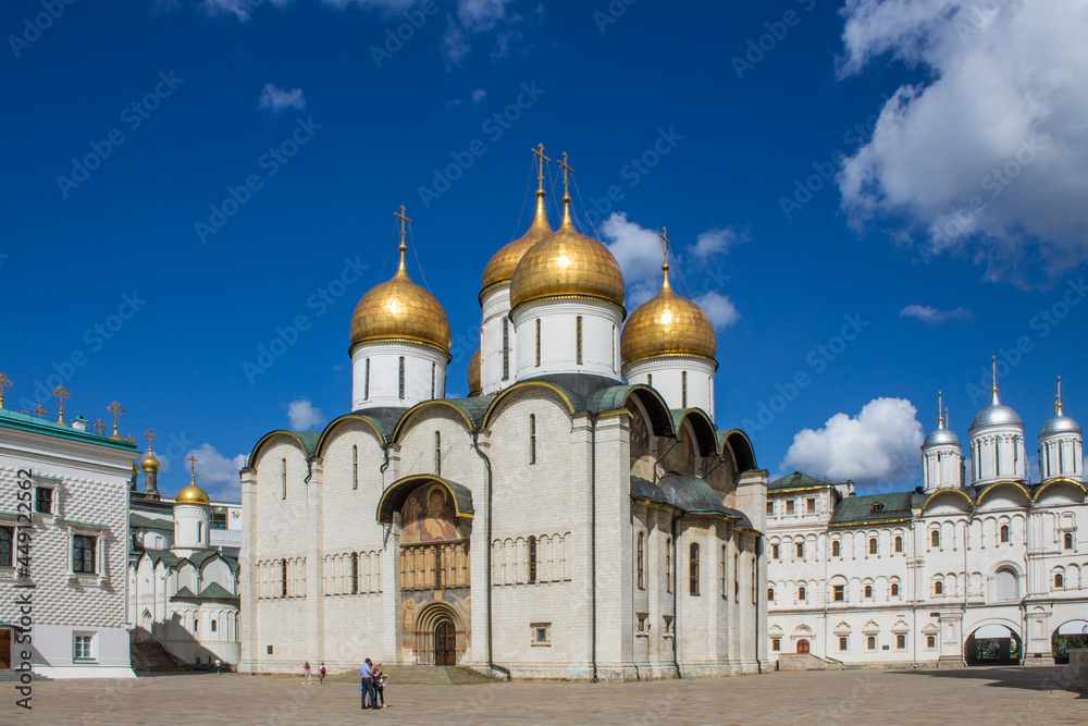 Cathedral of the Assumption of the Most Holy Theotokos with golden domes in the Kremlin on Cathedral Square on a sunny summer day in Moscow Russia
