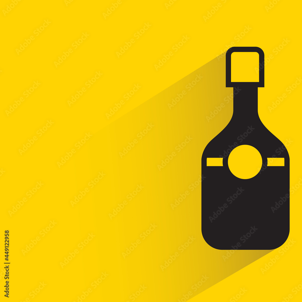 alcohol bottle with shadow on yellow background alcohol bottle with shadow on yellow background