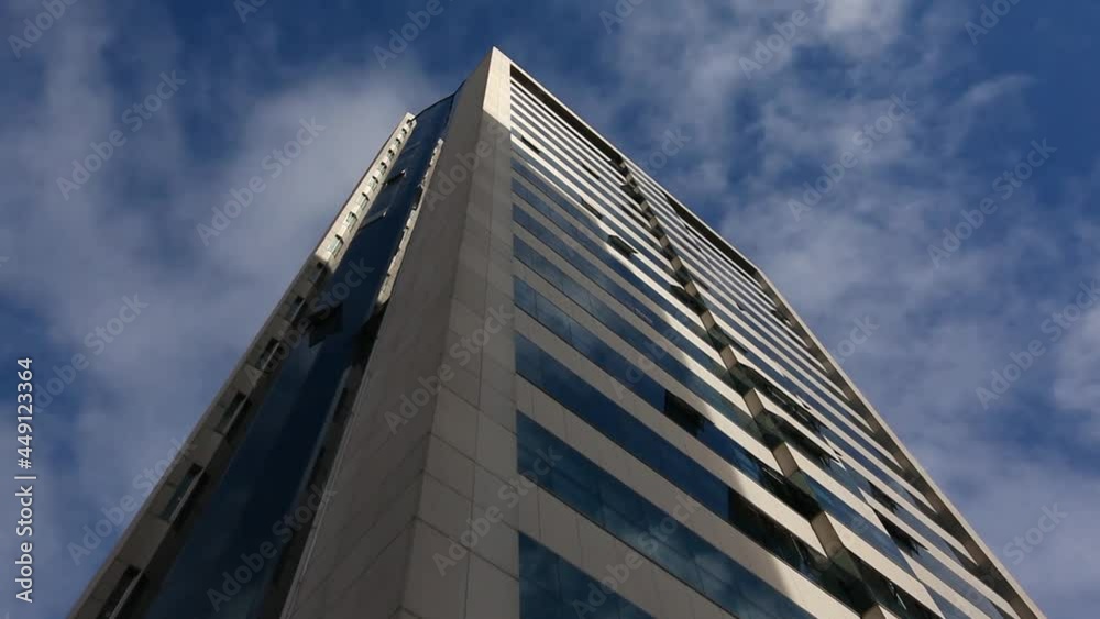 Time lapse of clouds seen by the reflection of the office building. Time lapse of clouds seen by the reflection of the office building.