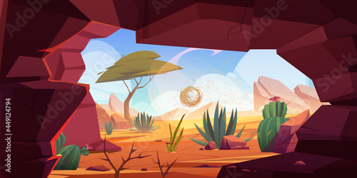 Desert cave entrance, hole in rock with cacti