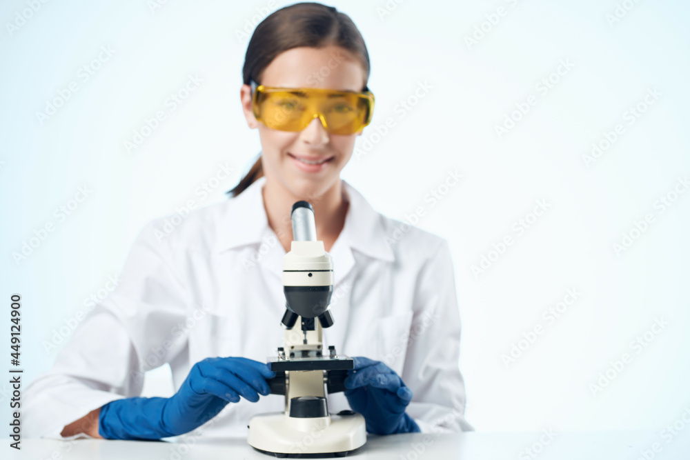 Woman in white coat laboratory microscope research biotechnology Woman in white coat laboratory microscope research biotechnology