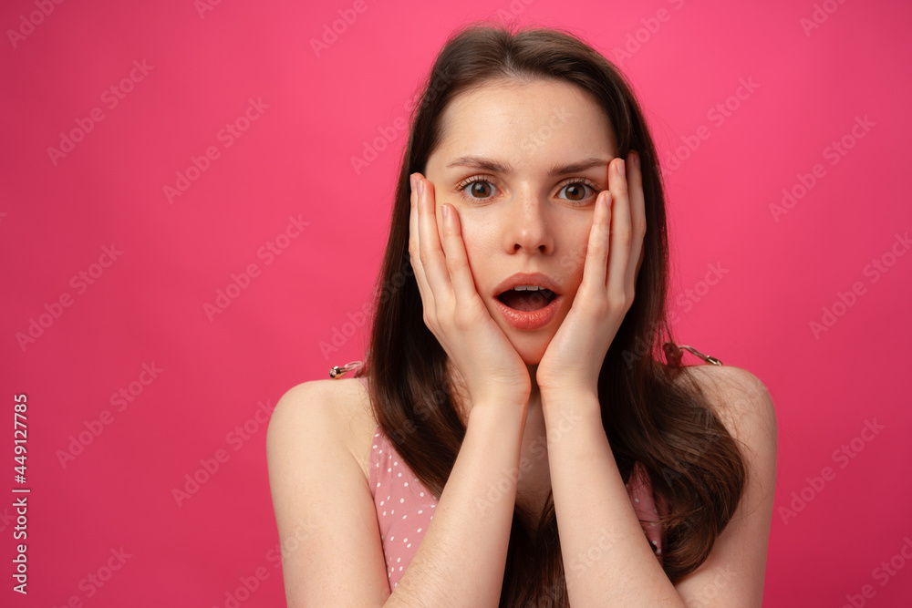 Shocked and surprised girl screaming against pink background Shocked and surprised girl screaming against pink background