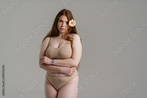 Young white plus size woman in lingerie posing photo