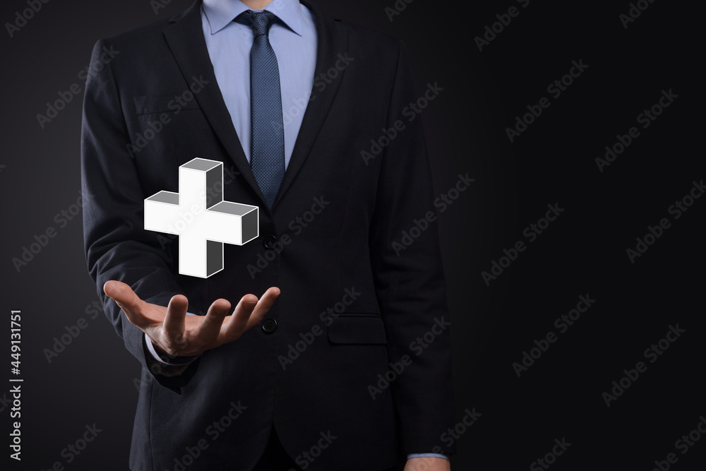 Businessman hold 3D plus icon, man hold in hand offer positive thing such as profit, benefits, development, CSR represented by plus sign.The hand shows the plus sign Businessman hold 3D plus icon, man hold in hand offer positive thing such as profit, benefits, development, CSR represented by plus sign.The hand shows the plus sign