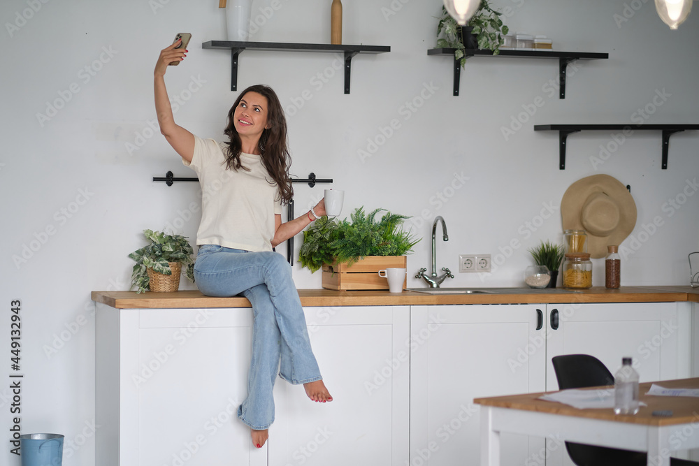 Young happy woman drinking coffee on the kitchen in the morning. Successful and confident female on a morning coffee break, resting and enjoying the drink. Young happy woman drinking coffee on the kitchen in the morning. Successful and confident female on a morning coffee break, resting and enjoying the drink.