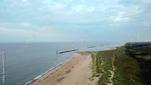 Wide landscape aerial shot flying over an empty British beach in Norfolk photo