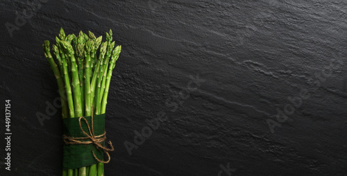 Asparagus from the garden on black stone background