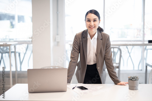 Portrait of successful business asian women in white shirt. with arms crossed and smile , Young businesswoman smiling and looking away Happy feeling concept