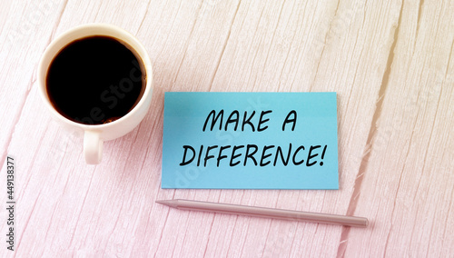 MAKE A DIFFERENCE text on the blue sticker with cofee and pen